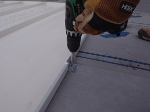 Screwing the clip to the roof decking