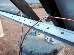 Close up of grounding lugs attached to the solar panels