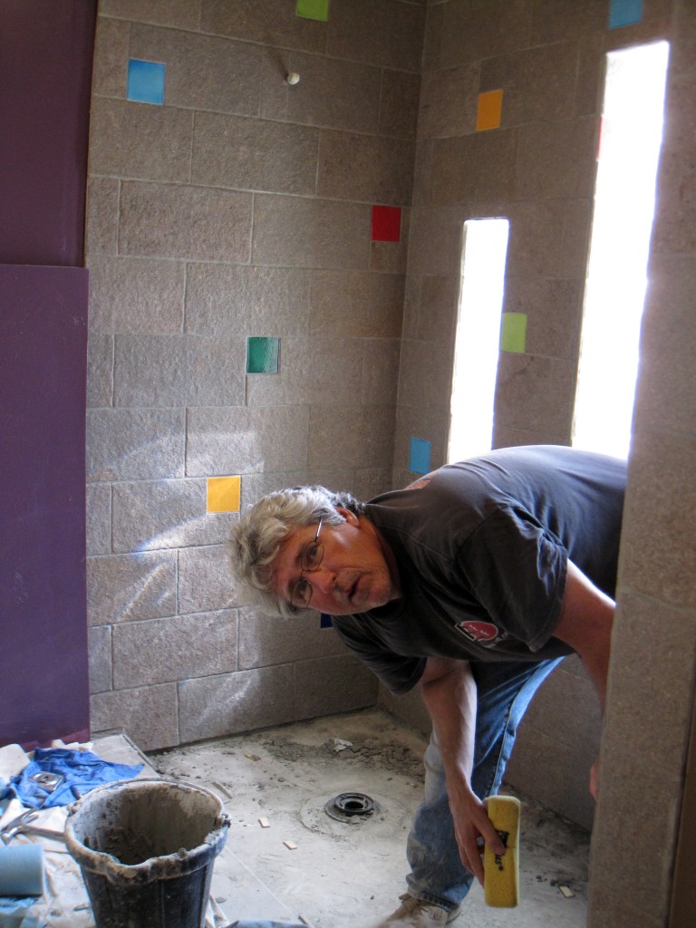 Brad hard at work (I cut most of the tile.)